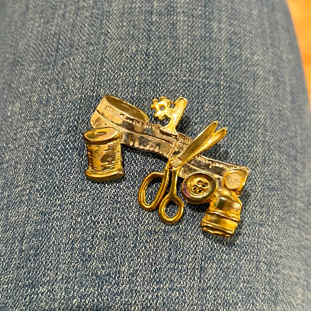Silver and gold metal sewing brooch or pin. Vintage item.